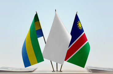 Flags of Gabon and Namibia with a white flag in the middle