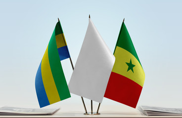 Flags of Gabon and Senegal with a white flag in the middle