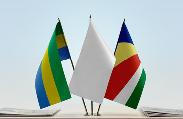 Flags of Gabon and Seychelles with a white flag in the middle