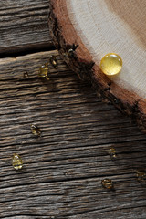 honey drops close-up on wooden boards and cross-section of pine trunk background
