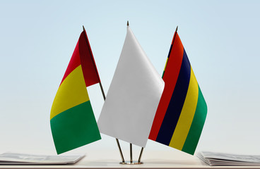 Flags of Guinea and Mauritius with a white flag in the middle
