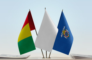 Flags of Guinea and Melilla with a white flag in the middle
