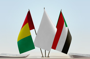 Flags of Guinea and Sudan with a white flag in the middle