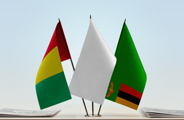 Flags of Guinea and Zambia with a white flag in the middle