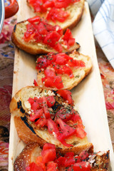 bruschettas on a wooden plate
