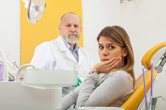 Female patient with toothache at the dentist office