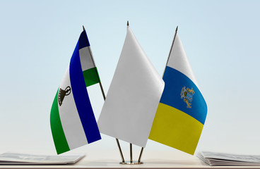 Flags of Lesotho and Canary Islands with a white flag in the middle