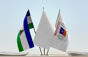 Flags of Lesotho and Mayotte with a white flag in the middle