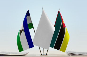 Flags of Lesotho and Mozambique with a white flag in the middle