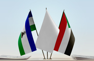 Flags of Lesotho and Sudan with a white flag in the middle