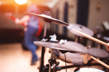 Fototapeta na wymiar Drums scene. Close-up of plate, drums, sticks, in background scene spotlights