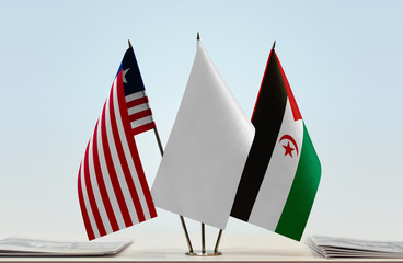 Flags of Liberia and Sahrawi Arab Democratic Republic with a white flag in the middle