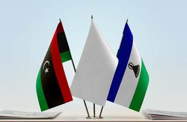 Flags of Libya and Lesotho with a white flag in the middle