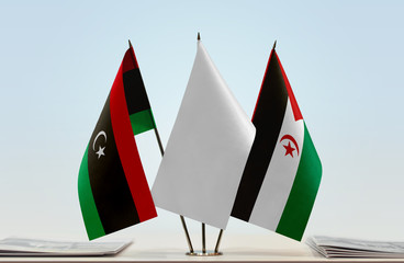 Flags of Libya and Sahrawi Arab Democratic Republic with a white flag in the middle