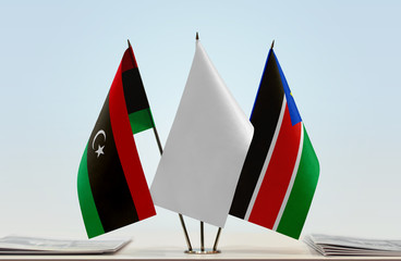 Flags of Libya and South Sudan with a white flag in the middle