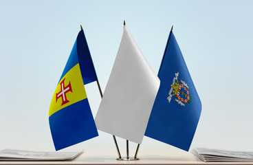 Flags of Madeira and Melilla with a white flag in the middle