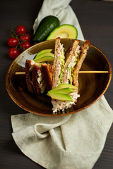 Top view of Healthy Sandwich toast with lettuce, ham, cheese and tomato on a wooden background