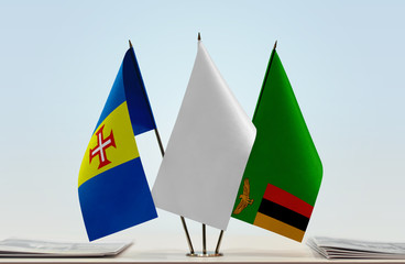 Flags of Madeira and Zambia with a white flag in the middle