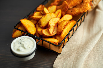 Nuggets and baked potatoes in a beautiful basket with white sauce