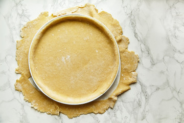 Rolling a pastry for baking a pie and pricking it with fork. Recipe concept