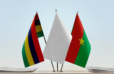 Flags of Mauritius and Burkina Faso with a white flag in the middle