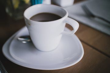 A cup of coffee with coffee stain on a cup with shallow depth of field