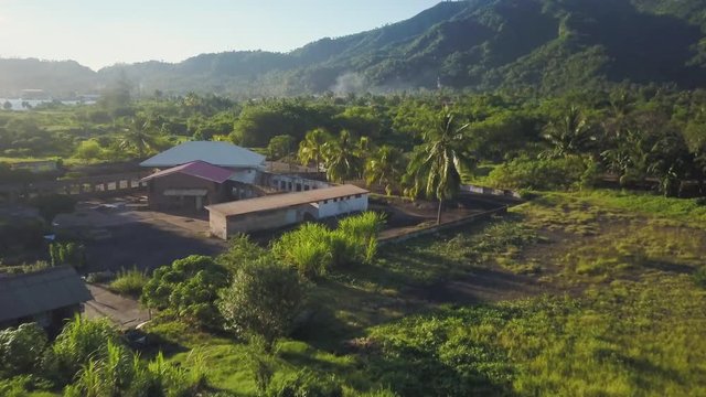 A birds eye view shot of house and trees. Camera moves forward