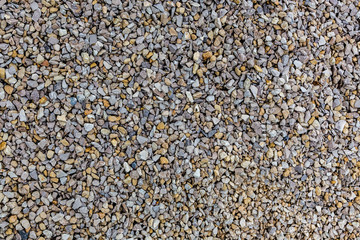 Close up of the gravel pattern. Background wall of rubble.