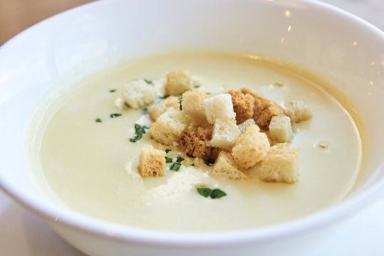 Delicious cheese soup. Small crackers. White dishes