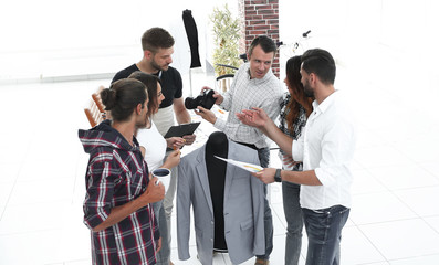 group of designers discussing new models of men's clothing.