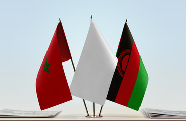 Flags of Morocco and Malawi with a white flag in the middle