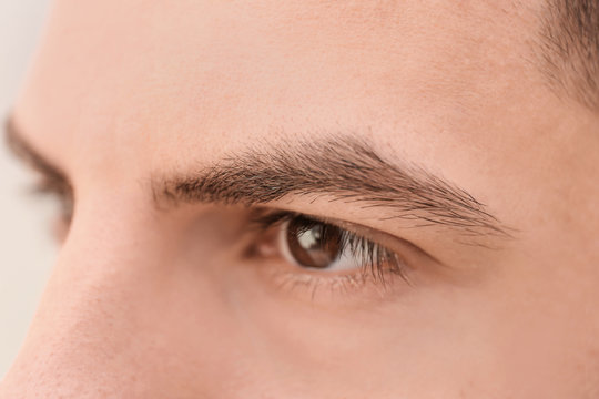 Young man with beautiful eyebrows, closeup