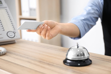 Female receptionist with card in hotel