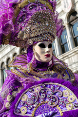 Fototapeta na wymiar Woman in violet mask at The Carnival of Venice 2018