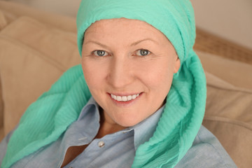 Mature woman with cancer in headscarf indoors