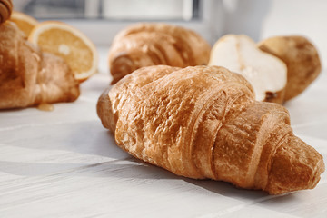 Tasty croissant on wooden table