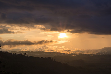 scene raining among a mountains during sunset