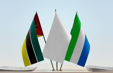 Flags of Mozambique and Sierra Leone with a white flag in the middle