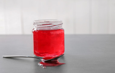 Fototapeta na wymiar Jar with sweet jam on table