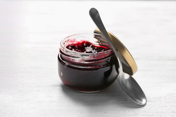 Jar with sweet jam on table