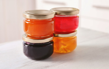 Fototapeta na wymiar Jars with sweet jams on table