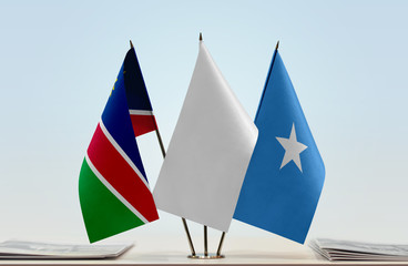 Flags of Namibia and Somalia with a white flag in the middle