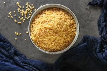 Bulgur on a dark background. Vegetarian Oriental food.