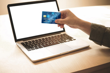 Payment online Concept .Man holding credit card and payment or shopping online whit blank computer screen.