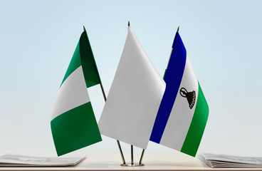 Flags of Nigeria and Lesotho with a white flag in the middle