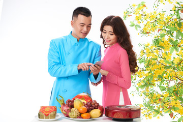 Couple reading messages for Tet