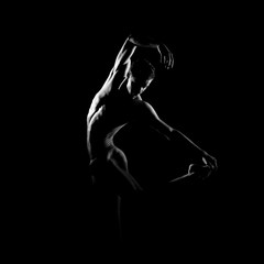 Black and white silhouette of male ballet dancer.