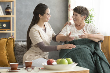 Happy senior woman and caregiver