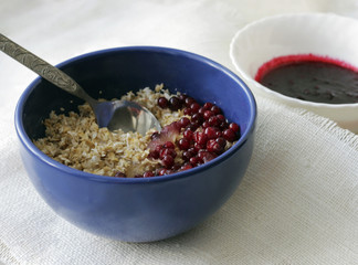Oatmeal porridge with berries. Berry jam. Healthy breakfast.
