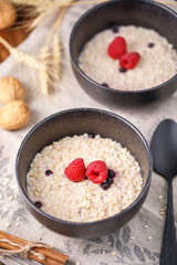 Appetizing and healthy breakfast. Oatmeal with fresh raspberries.